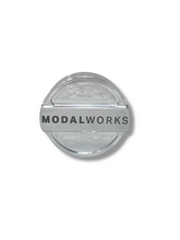 Load image into Gallery viewer, Round metallic object with 'Modalworks' branding on a white background