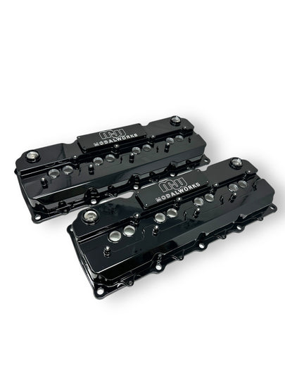 Top view of ModalWorks Gen 3 Hemi billet valve cover in black finish, showing smooth CNC‑machined surface and dual breather ports