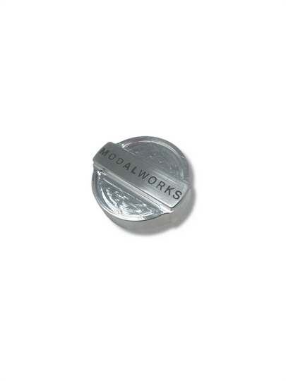 Metallic cap with 'MODALWORKS' branding on a white background