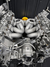 Load image into Gallery viewer, ModalWorks equal-length M177 exhaust manifolds installed in the hot-vee of an AMG 4.0L V8, V-band turbo flanges up
